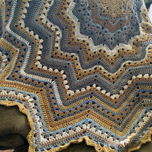 Load image into Gallery viewer, Close-up of a gray, tan, mustard, and cream crochet Superstar blanket with blue accents, showing granny clusters and zigzag rows.